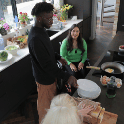 Disabled woman in wheelchair sitting in kitchen with friends