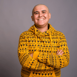 Happy man with arms crossed smiling at camera