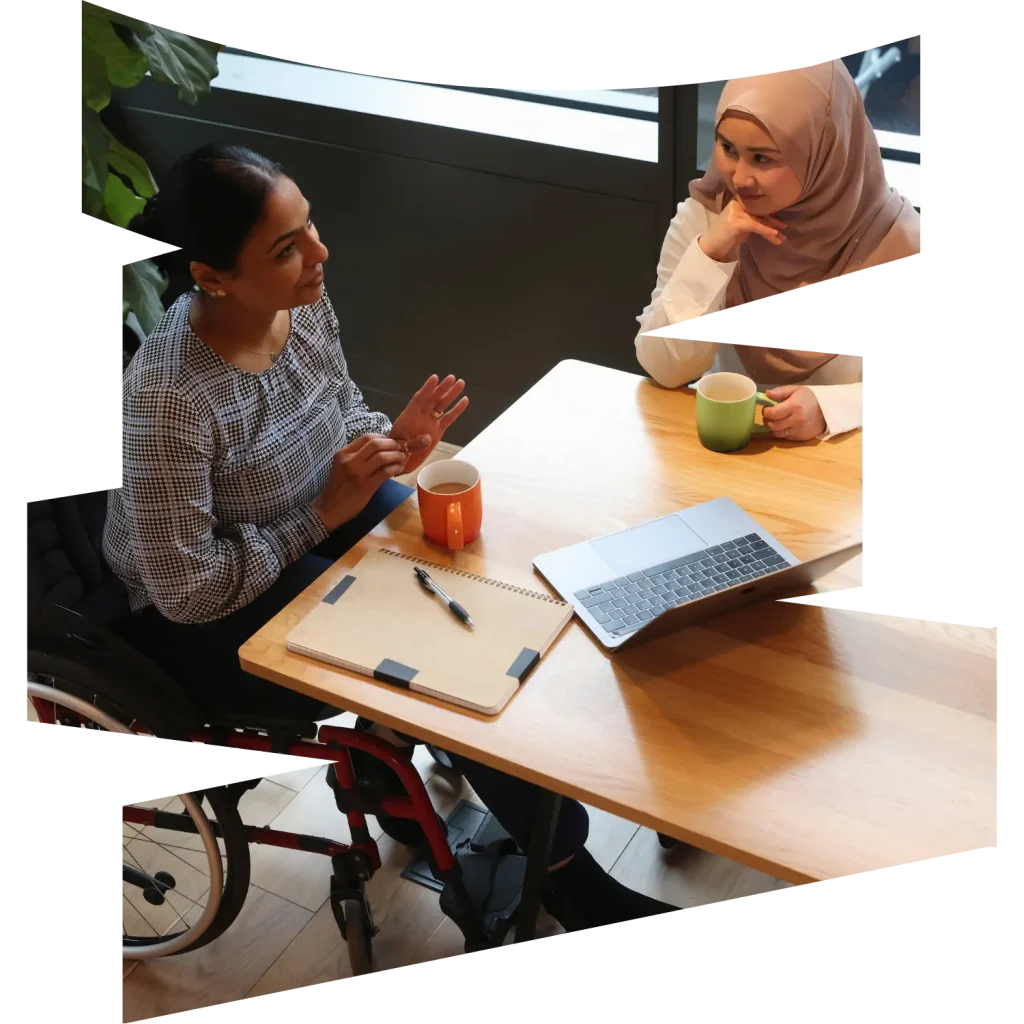 Disabled woman in wheelchair speaking with support worker