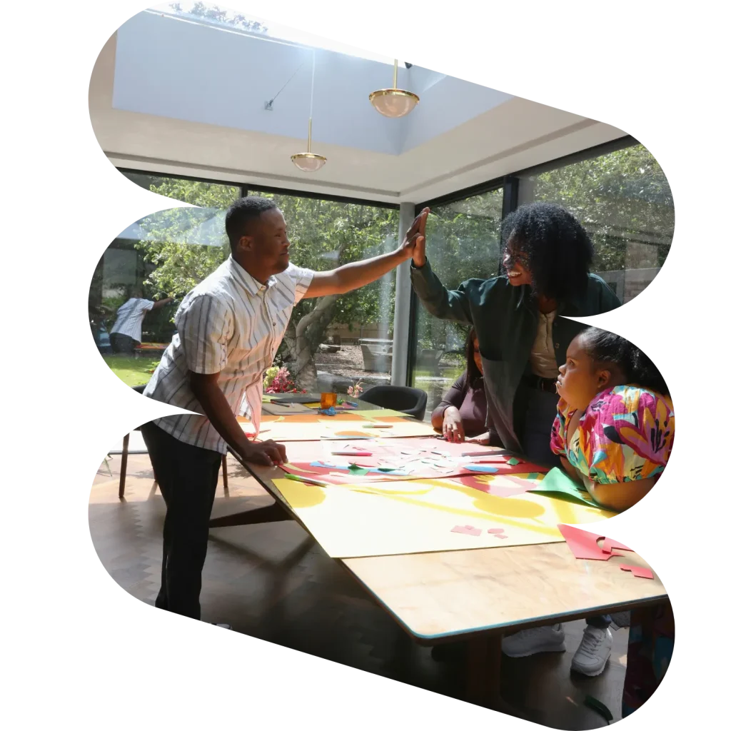 Disabled man with down syndrome high fiving support worker