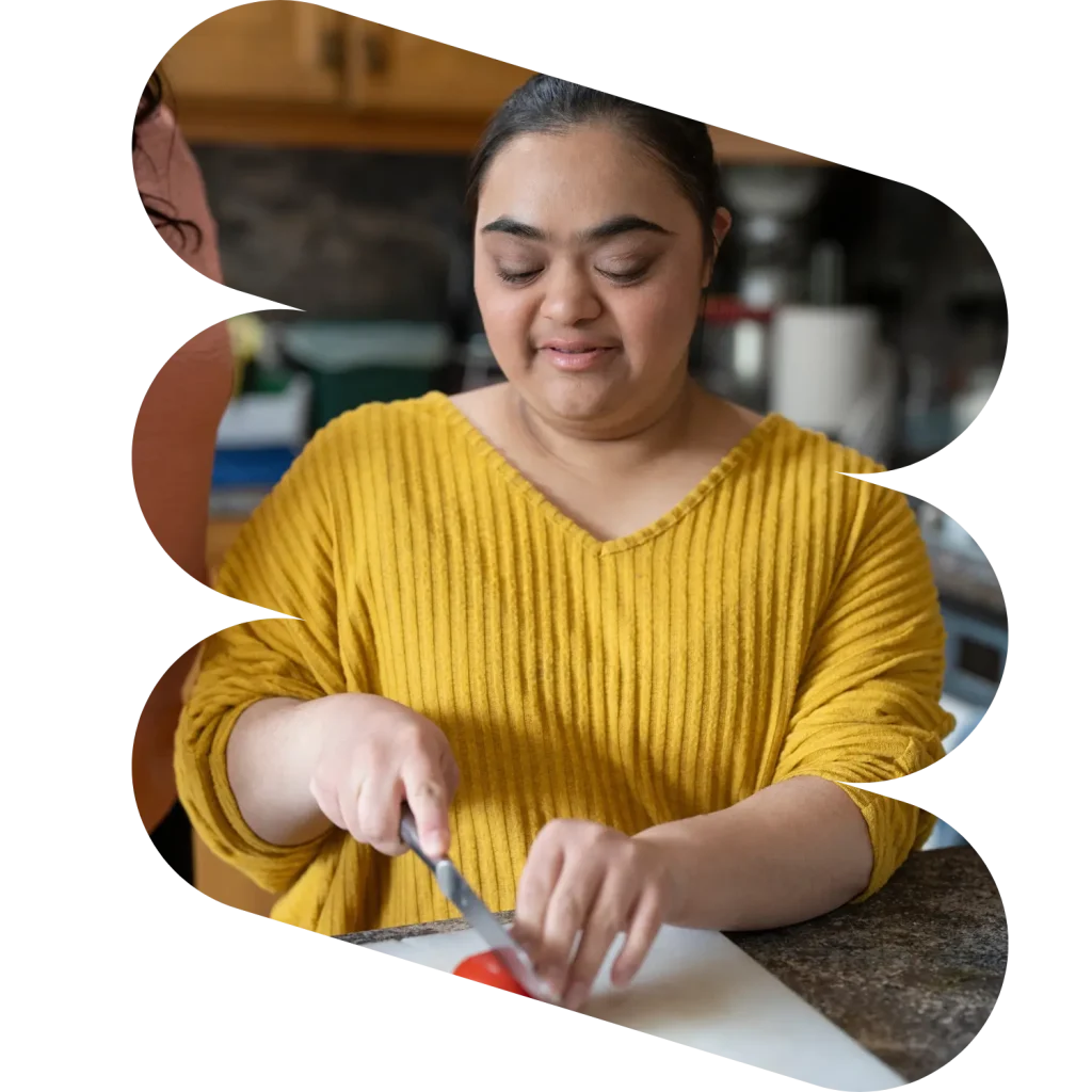 Disabled woman chopping vegetables in kitchen