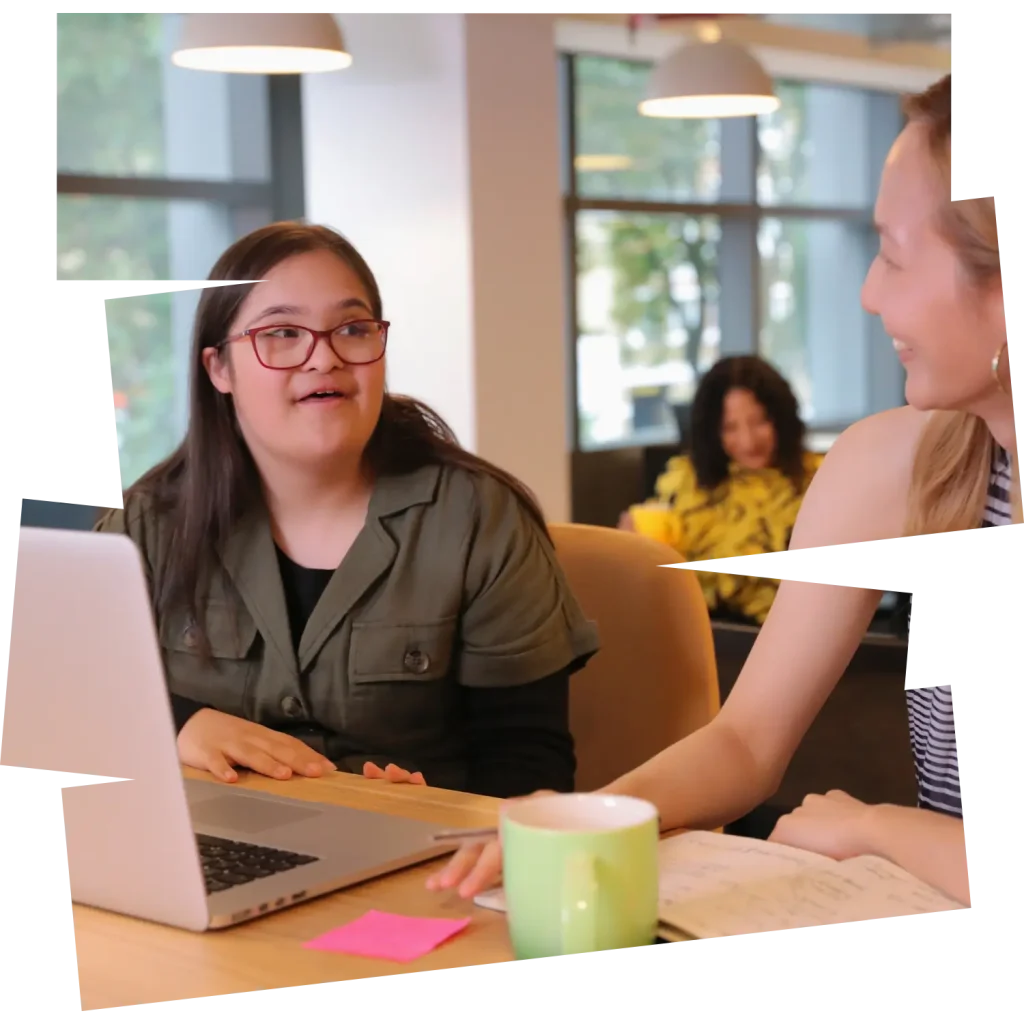 Disabled woman with down syndrome smiling with support worker